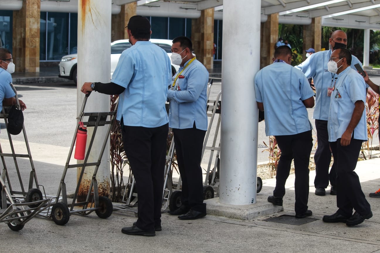 Maleteros se quejan de turistas que incumplen medidas anticovid en aeropuerto de Cancún