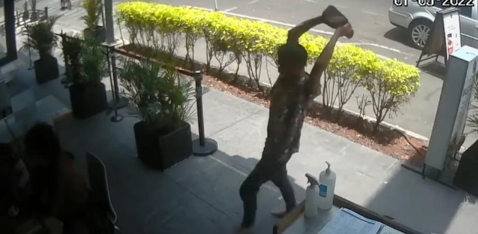 Momento en el que un hombre lanza un tabique al joven en restaurante de la CDMX